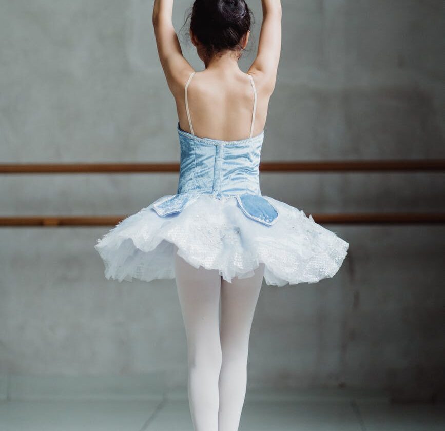 ballet dancer on tiptoes with hands up