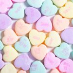 a large pile of candy hearts with the words love you